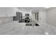 Open kitchen with bright countertops, stainless steel appliances and sleek white cabinets at 7803 Canoe Ln, Las Vegas, NV 89145
