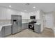 Charming kitchen featuring new stainless steel appliances, grey cabinets, and white countertops at 7803 Canoe Ln, Las Vegas, NV 89145