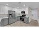 Contemporary kitchen boasts stainless steel appliances, two-tone cabinets, and recessed lighting at 7803 Canoe Ln, Las Vegas, NV 89145