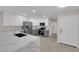 Spacious updated kitchen with stainless steel appliances and modern countertops with seating at the bar at 7803 Canoe Ln, Las Vegas, NV 89145