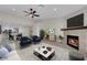 Bright living room featuring a fireplace, tile flooring, and seamless flow into the kitchen at 7803 Canoe Ln, Las Vegas, NV 89145