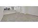Open living room with tile flooring and a modern kitchen featuring a breakfast bar at 7803 Canoe Ln, Las Vegas, NV 89145