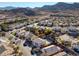 Picturesque aerial view showcases a neighborhood's cozy homes and shared community pool nestled near scenic mountains at 793 Vortex Ave, Henderson, NV 89002