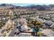 An aerial view of a residential neighborhood featuring a community pool surrounded by houses and lush greenery at 793 Vortex Ave, Henderson, NV 89002