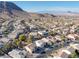 Expansive aerial view displays a residential area with tree-lined streets, manicured lawns, and community pools at 793 Vortex Ave, Henderson, NV 89002