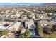 A high-angle shot shows a neighborhood with mountain views, featuring well-maintained homes and mature landscaping at 793 Vortex Ave, Henderson, NV 89002