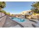 Backyard featuring a private pool, spa and entertaining space in lush landscaping at 793 Vortex Ave, Henderson, NV 89002
