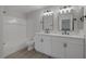 Bathroom with double vanity featuring white cabinetry, sleek hardware and a shower and tub combo at 793 Vortex Ave, Henderson, NV 89002