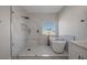 The elegant bathroom features marble tile, a glass-enclosed shower, and a soaking tub for a spa-like retreat at 793 Vortex Ave, Henderson, NV 89002