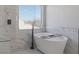 This bathroom features a standalone tub with a window view, marble tiling, and glass shower at 793 Vortex Ave, Henderson, NV 89002