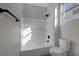 Clean bathroom with a tub/shower, white tile surround, modern fixtures, and a toilet at 793 Vortex Ave, Henderson, NV 89002
