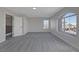 Spacious bedroom with new carpet, natural light from two windows and access to the upstairs hallway at 793 Vortex Ave, Henderson, NV 89002