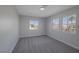 This bedroom features gray walls, gray carpet, and multiple windows with views at 793 Vortex Ave, Henderson, NV 89002