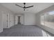 Bright and airy bedroom with carpet flooring, ceiling fan, and access to two closets at 793 Vortex Ave, Henderson, NV 89002