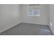 Neutral bedroom with a window looking out to the backyard and soft carpeting at 793 Vortex Ave, Henderson, NV 89002