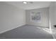 This bedroom features gray walls, gray carpet, and a window at 793 Vortex Ave, Henderson, NV 89002