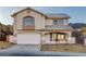 Two-story home with a neutral color scheme, arched window, tile roof, and a two-car garage at 793 Vortex Ave, Henderson, NV 89002