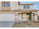Inviting two-story home with a covered front porch, well-manicured lawn, and a two-car garage at 793 Vortex Ave, Henderson, NV 89002