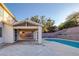 Inviting backyard with pool, spa, covered patio, and well-maintained landscaping, perfect for outdoor entertaining at 793 Vortex Ave, Henderson, NV 89002