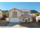 Charming two-story home featuring a tile roof, arched window, covered porch, and attached two car garage at 793 Vortex Ave, Henderson, NV 89002