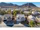 Aerial view of home showcasing landscaping, attached two car garage, and mountain views in the background at 793 Vortex Ave, Henderson, NV 89002