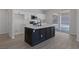Bright kitchen with white cabinets, black hardware, a large island, and seamless flow to outdoor pool area at 793 Vortex Ave, Henderson, NV 89002
