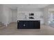 Bright, modern kitchen with white cabinets, black island and stainless steel appliances at 793 Vortex Ave, Henderson, NV 89002