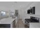 Open kitchen with island, white quartz countertops, subway tile backsplash, stainless appliances, and modern fixtures at 793 Vortex Ave, Henderson, NV 89002