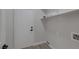 Functional laundry room with a white door, overhead shelving, and utility hookups at 793 Vortex Ave, Henderson, NV 89002