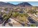 Neighborhood view showcasing well-maintained homes, palm trees, a basketball court and mountain views in the background at 793 Vortex Ave, Henderson, NV 89002