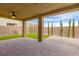 This backyard has a covered patio, artificial grass and a view of the surrounding desert landscape at 806 Neath Ave, Las Vegas, NV 89178