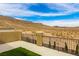 This balcony features neutral color walls and stone posts along with amazing desert landscape views at 806 Neath Ave, Las Vegas, NV 89178