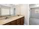 This bathroom has a double sink vanity with granite counters and wood cabinets plus a walk-in closet at 806 Neath Ave, Las Vegas, NV 89178