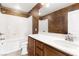 This bathroom features a shower and tub combination along with a single sink vanity with granite counters and wood cabinets at 806 Neath Ave, Las Vegas, NV 89178