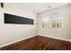 Bright bedroom featuring hardwood floors and sun-filled windows with views of the outdoors at 806 Neath Ave, Las Vegas, NV 89178