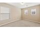 Bright bedroom with neutral paint, plush carpet and multiple windows providing natural light at 806 Neath Ave, Las Vegas, NV 89178
