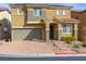 Inviting two-story home features a charming front yard, two car garage and a red tile roof at 806 Neath Ave, Las Vegas, NV 89178