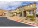 Inviting two-story home features a charming front yard, two car garage and a red tile roof at 806 Neath Ave, Las Vegas, NV 89178