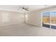 Spacious main bedroom featuring neutral walls and carpeting with a sliding door to a balcony overlooking desert landscape at 806 Neath Ave, Las Vegas, NV 89178