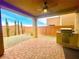 A covered patio featuring a ceiling fan, brick pavers, and a built-in grill at 806 Neath Ave, Las Vegas, NV 89178