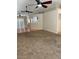Spacious living room features neutral carpet, ceiling fan, and lots of natural light from the windows at 807 Airy Hill St, Henderson, NV 89015