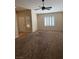 Inviting living room features neutral carpet, ceiling fan, and a large window for lots of natural light at 807 Airy Hill St, Henderson, NV 89015