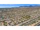 Wide aerial view of a Primary-planned community with mature trees, manicured lawns, and stunning mountain views at 8100 Artistic Heights Ct, Las Vegas, NV 89143