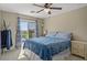 Bedroom featuring balcony access, ceiling fan, and neutral toned walls at 8100 Artistic Heights Ct, Las Vegas, NV 89143