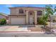 Charming two-story home featuring manicured landscaping, arched entryway, and a spacious two-car garage at 8100 Artistic Heights Ct, Las Vegas, NV 89143