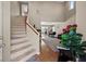 Inviting entryway showcases hardwood floors, staircase, and an open floor plan leading to the dining and living areas at 8100 Artistic Heights Ct, Las Vegas, NV 89143