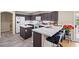 Modern kitchen features quartz countertops, dark cabinets, stainless appliances, and wood flooring at 8100 Artistic Heights Ct, Las Vegas, NV 89143