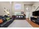 Spacious living room with large windows, two-story ceiling, hardwood floors, and neutral colors at 8100 Artistic Heights Ct, Las Vegas, NV 89143