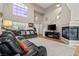 Bright living room showcases two-story ceiling, modern fireplace, and hardwood flooring at 8100 Artistic Heights Ct, Las Vegas, NV 89143
