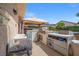Outdoor kitchen featuring a built-in grill, countertop space, and convenient storage at 8100 Artistic Heights Ct, Las Vegas, NV 89143